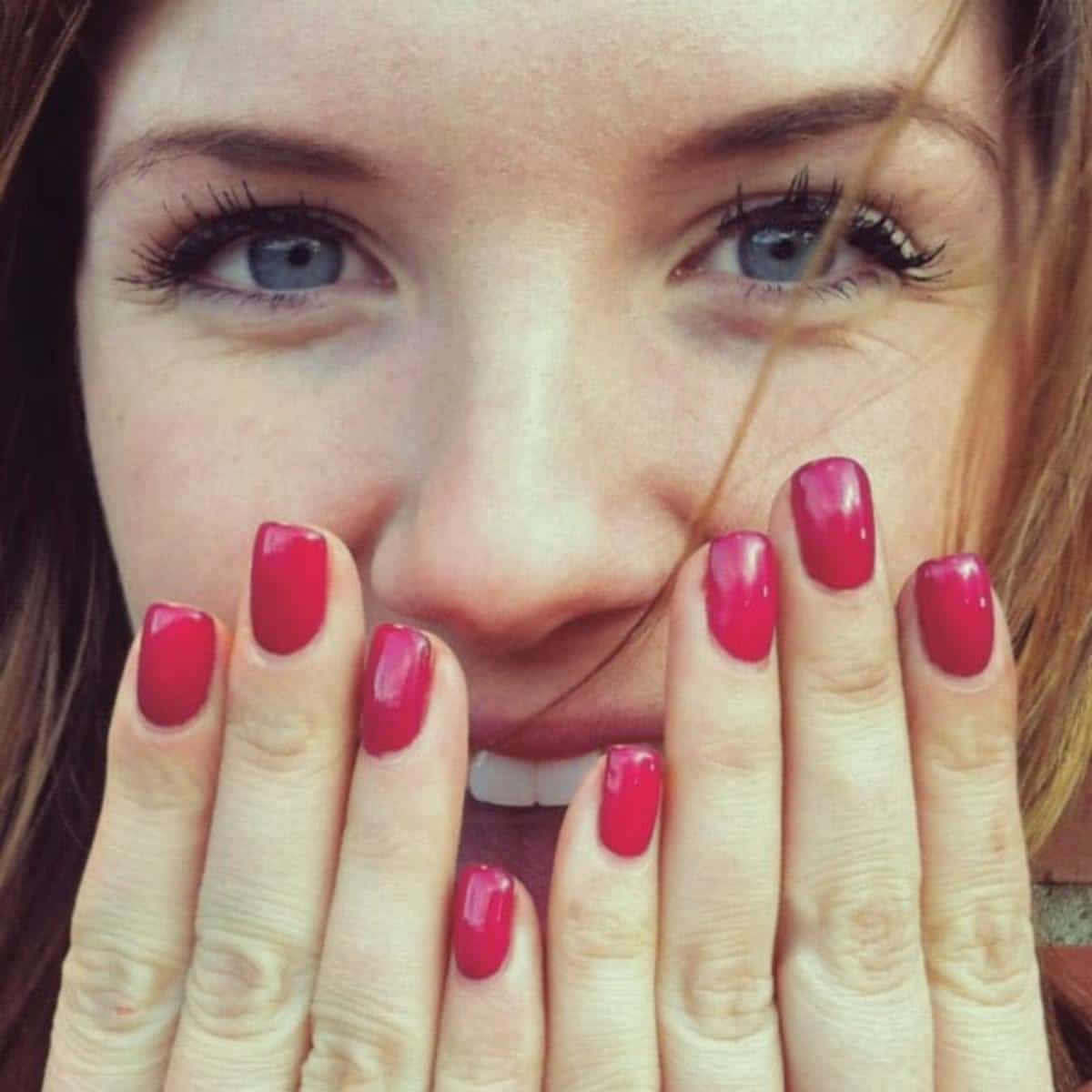 Smiling woman with Shellac Manicure.