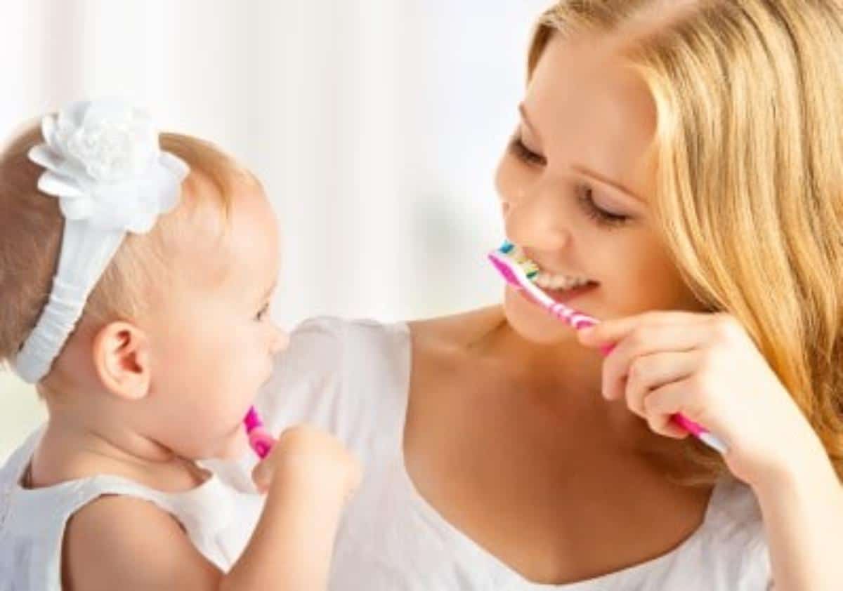 A mother and a daughter cleaning teeth