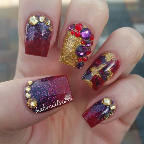 Gold, purple, and red sparkly nails
