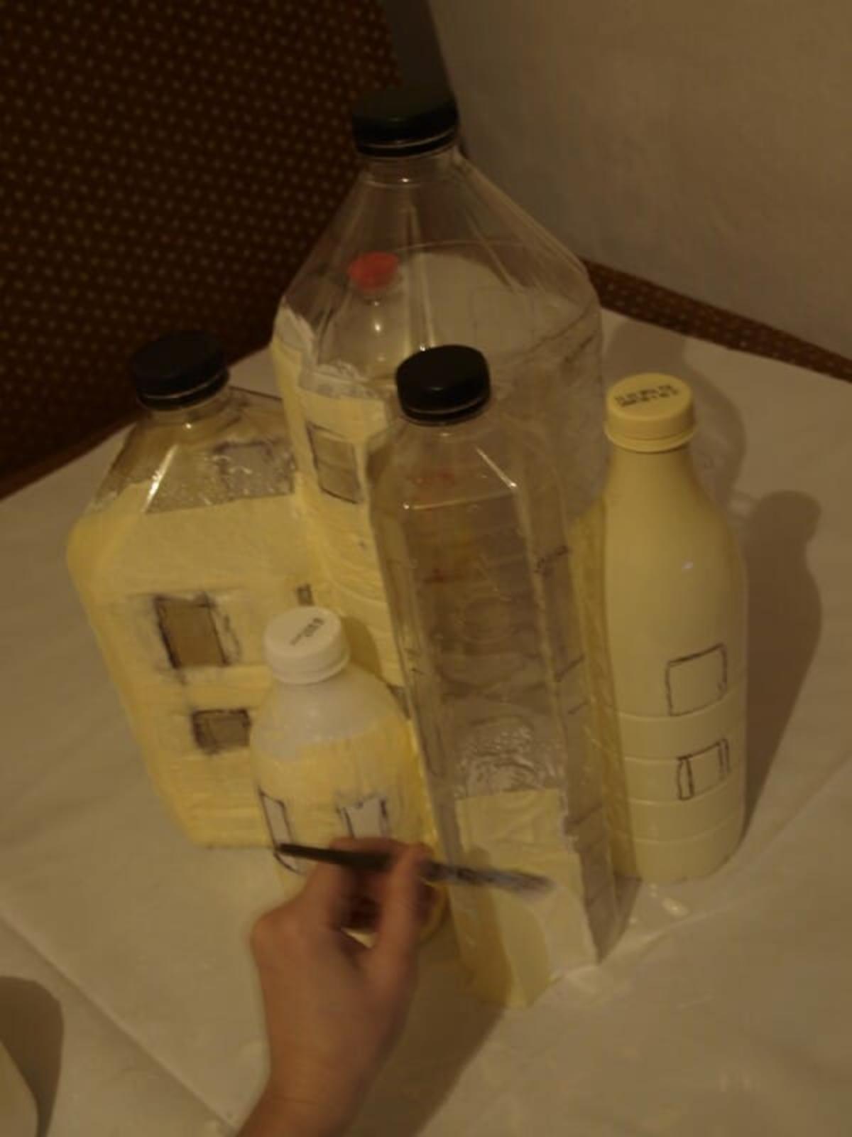 Covering bottles in wood glue and paper towels
