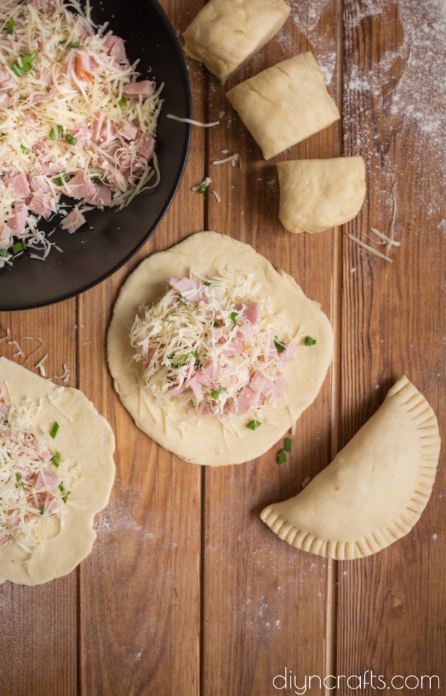 Filling dough with ham and cheese.