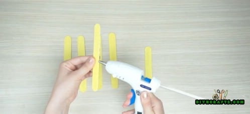Use your hot glue gun to glue two of them together.
