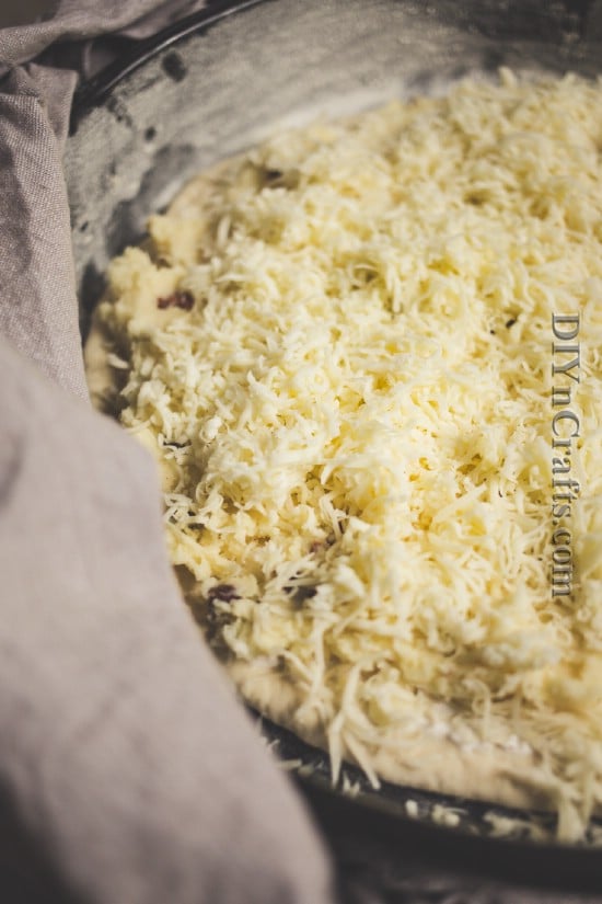 Spread potato filling onto premade pizza crust and top with cheese