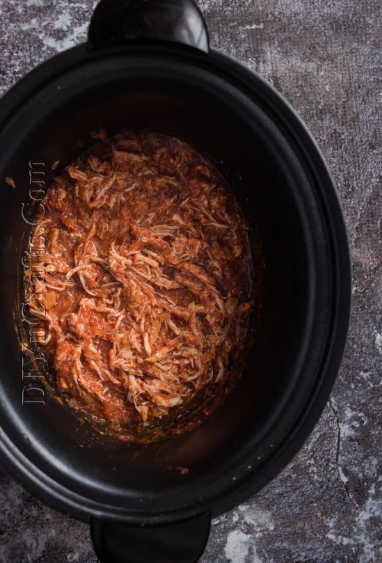 Mixing the pulled pork with the sauce.