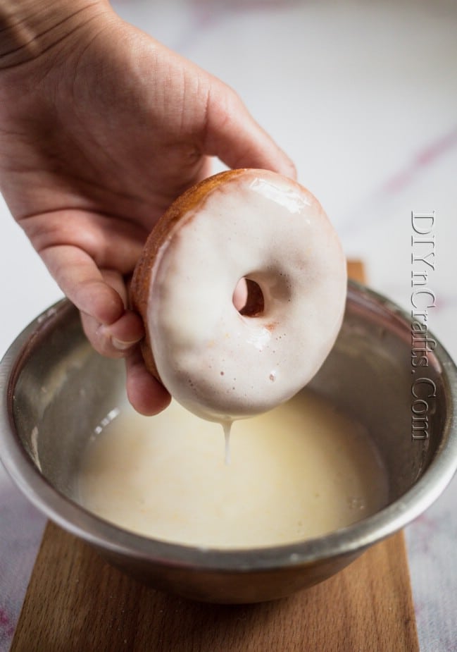 Adding glaze and toppings the donuts