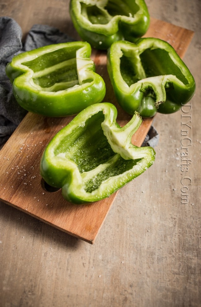 Cutting bell peppers evenly in half.