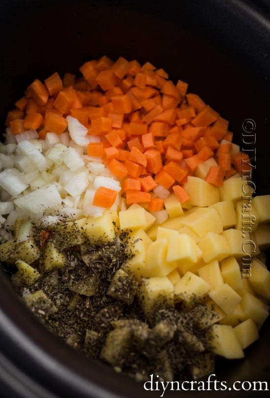 Adding ingredients to the slow cooker.