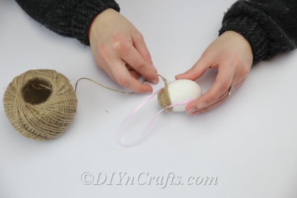 Glue the ribbon to the middle of the egg.