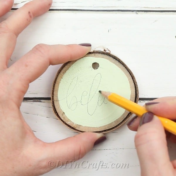Write words onto paint on wood slices 