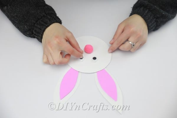 Glue the googly eyes to the bunny's face.
