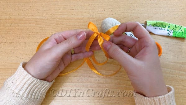 Glue ribbon onto the center of the egg
