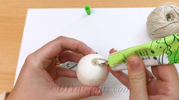 Wrap twine around the egg, gluing it in place