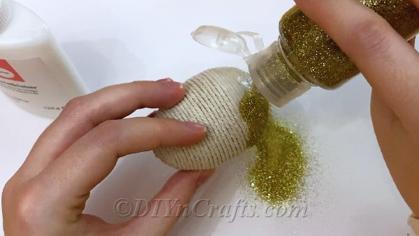 Add glitter over glue and allow to dry