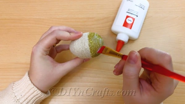 Add glue on top of the glitter and even it with a paintbrush