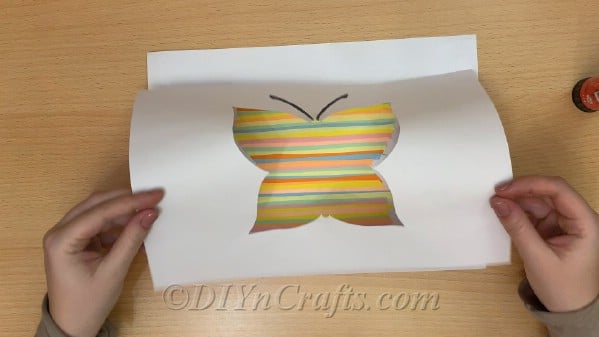 Cover colored strips with printable butterfly template and glue into place