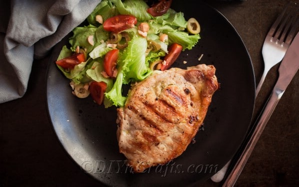 Grilled stuffed pork chops with salad 