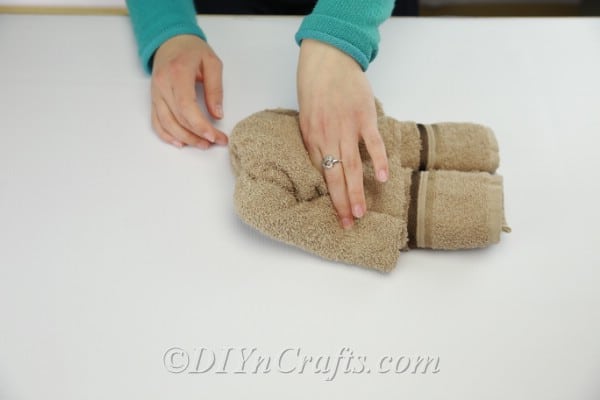 Washcloth folded and rolled to create a teddy bear