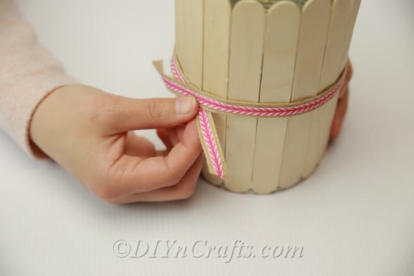 Adding ribbon to the outside of popsicle stick pencil holder