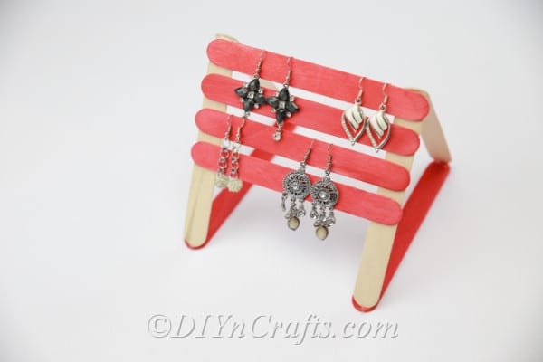 Earring organizer made from popsicle sticks with earrings