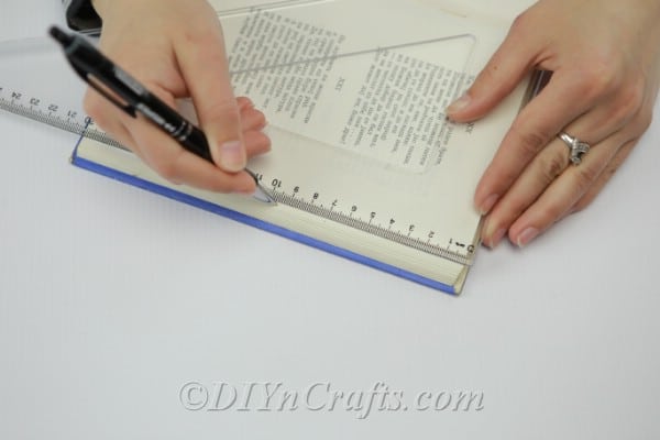 Measuring marks on book pages with a ruler