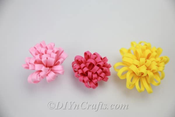 Finished DIY fabric flowers in red, yellow, and pink
