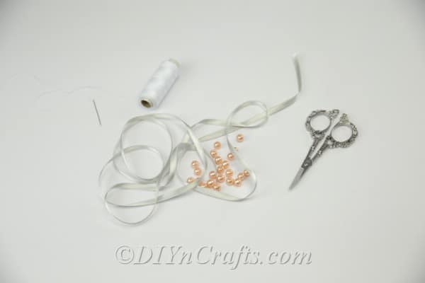 Supplies needed to make a ribbon and pearl bracelet