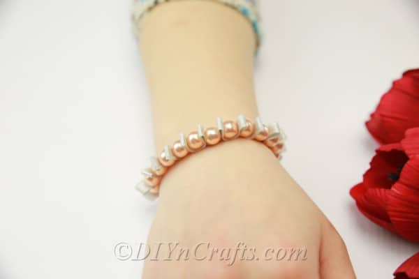 Close up image of pearl and ribbon bracelet
