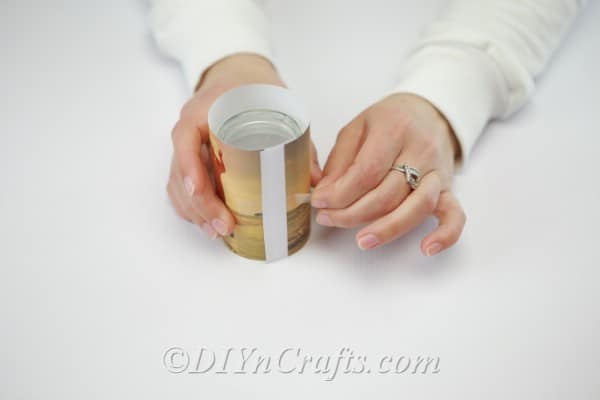 Taping a photo to the outside of an empty jar