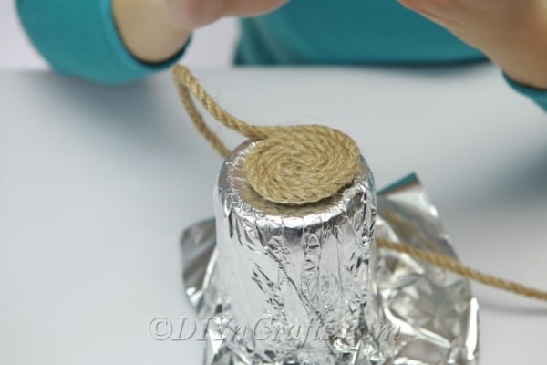 Covering a foil covered jar completely with rope