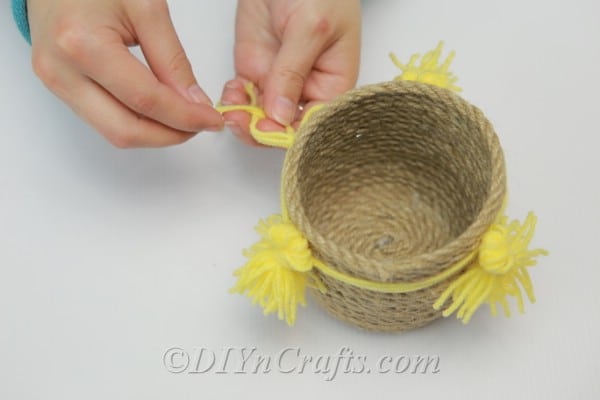 Gluing tassels onto a rope basket