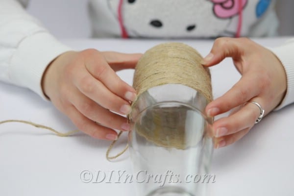 Wrapping and gluing twine up a glass bottle