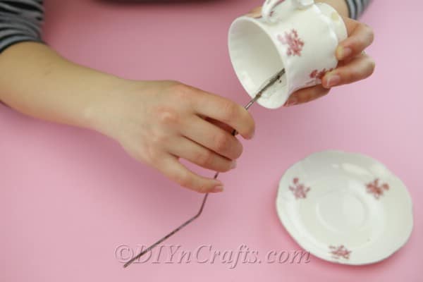 Gluing wire into the inside of an old teacup