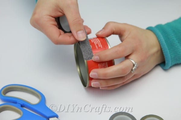 Wrapping an empty tuna can with Washi tape