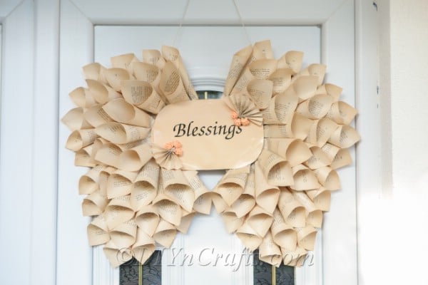 Angel wings decoration hanging on a white door