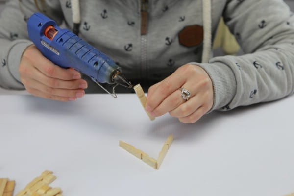 Adding glue to clothespins to hold them together