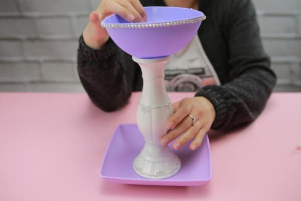 Purple plates with a white candlestick between them
