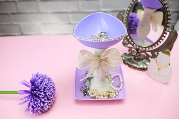Top view of jewelry holder with mirror and purple scrunchies 