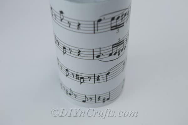 Close up image of a music sheet covered jar