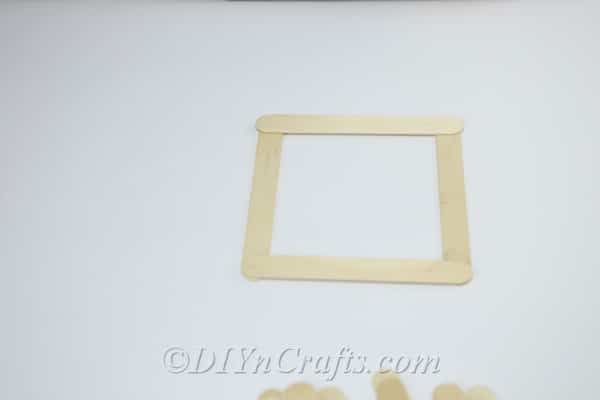 Make a square shape from craft sticks.