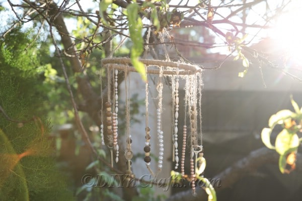 Your DIY rustic wind chime looks lovely in the sunlight.