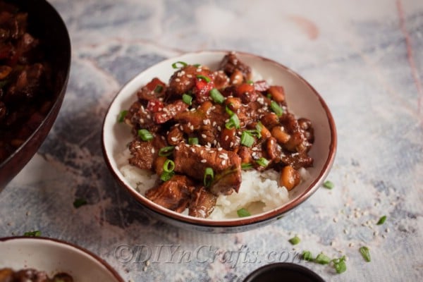Kung pao chicken in a bowl over rice