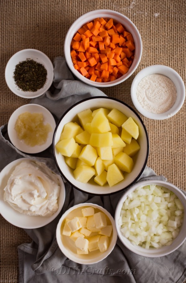 Soup ingredients in white bowls laying on a table