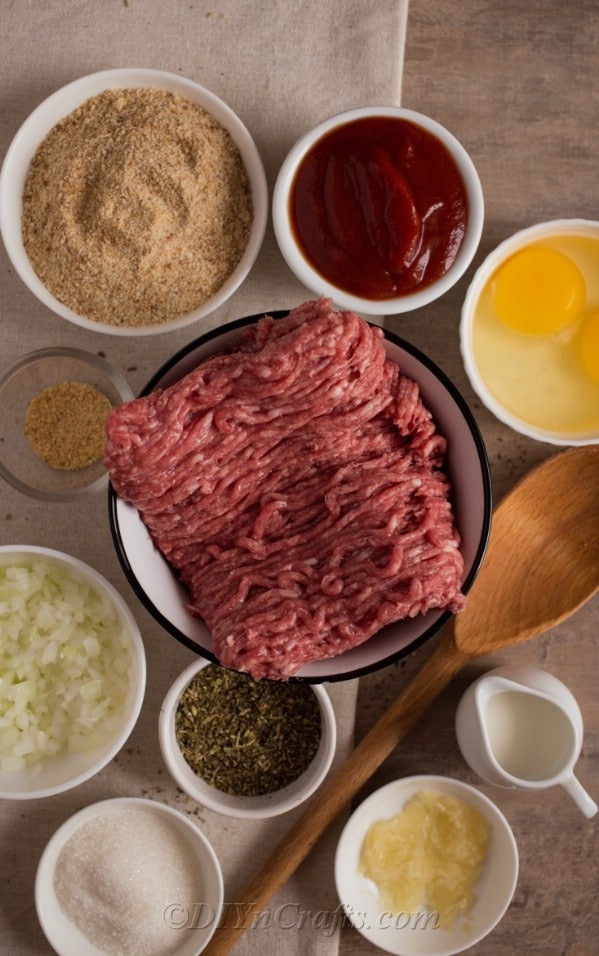 Ingredients for glazed bbq meatloaf recipe pre-measured in white bowls