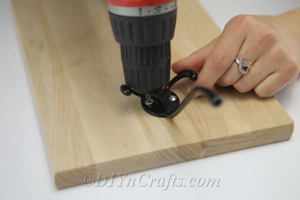 Attach the hook to the board with screws.