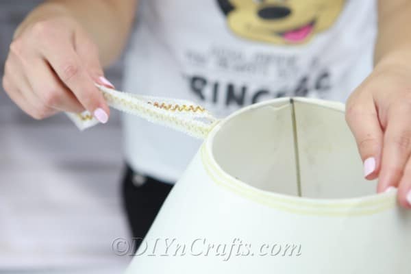 Continue removing unwanted embellishments from the lampshade.