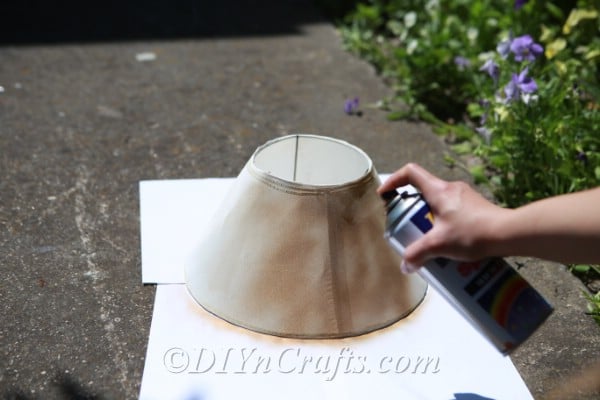 Apply spray paint to your lampshade.