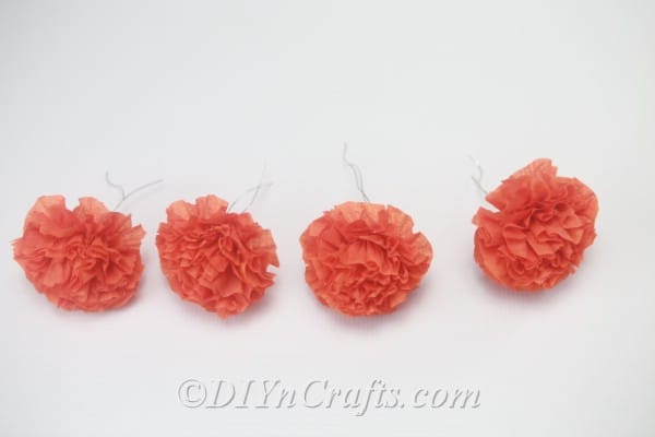 Repeating the previous steps three more times will give you a total of four small tissue paper flowers.