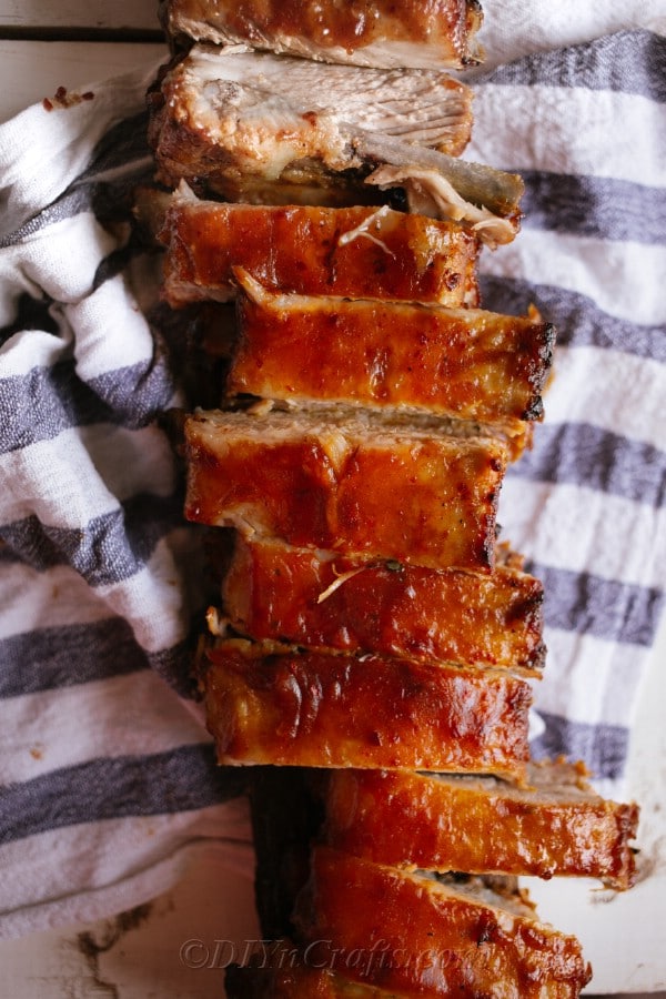A slab of oven baked ribs on a white and blue towel