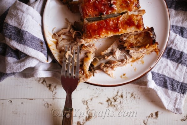 A white plate of seasoned bbq pork ribs baked in the oven