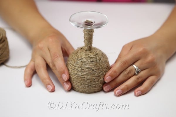 The wine glass is covered in twine.